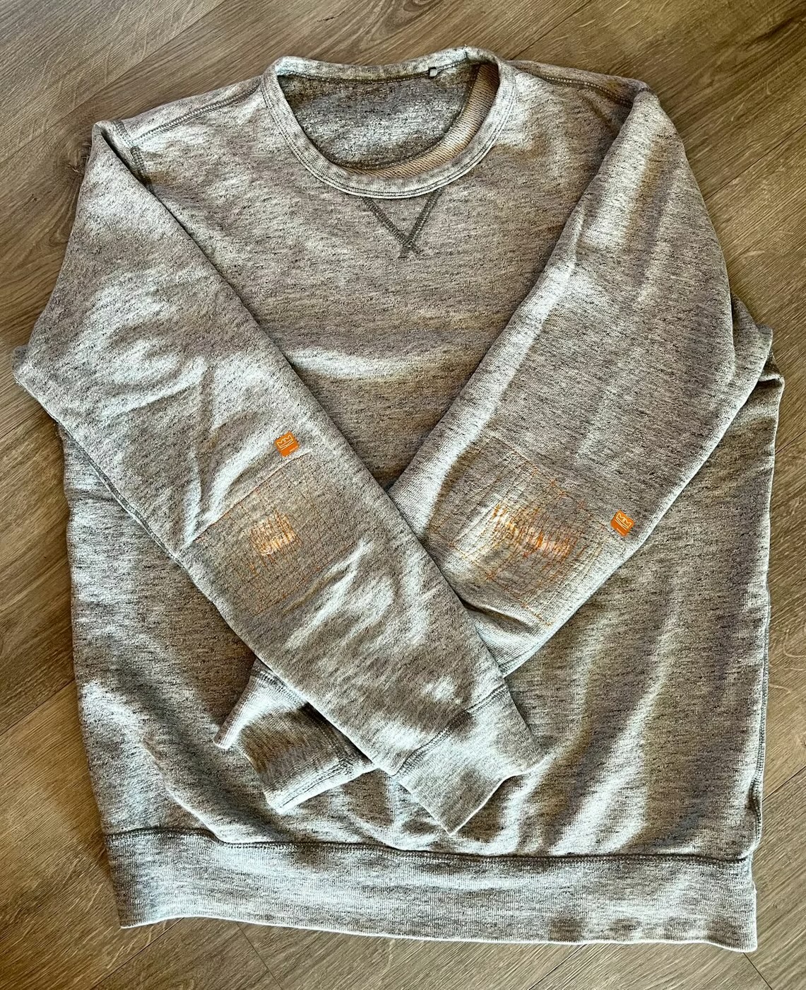 Grey sweater with branded MMSZ elbow patches